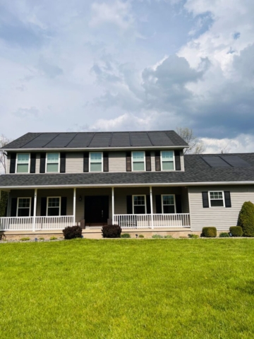 A home in Hermitage PA with solar panels and Timberline HDZ tiles in charcoal.